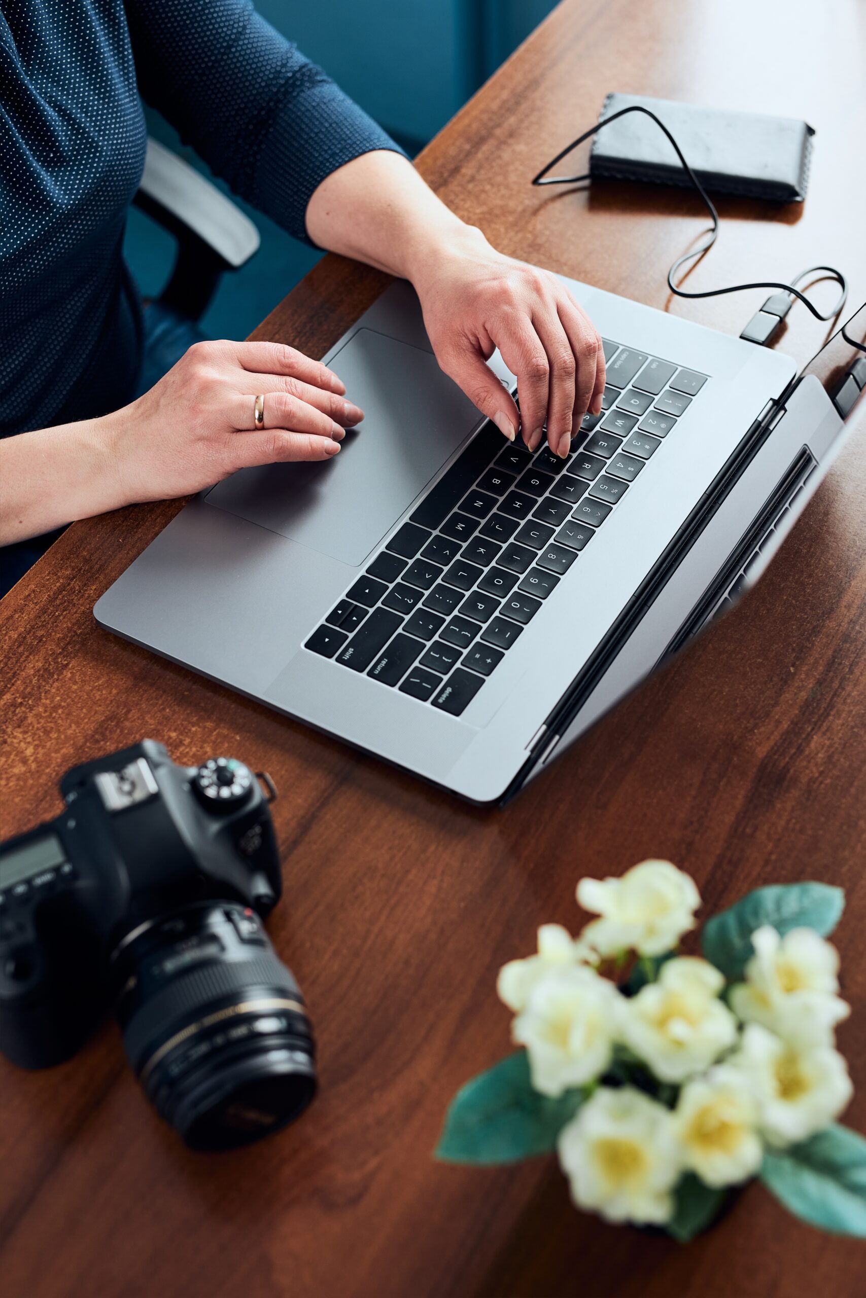 Female working on laptop and camera