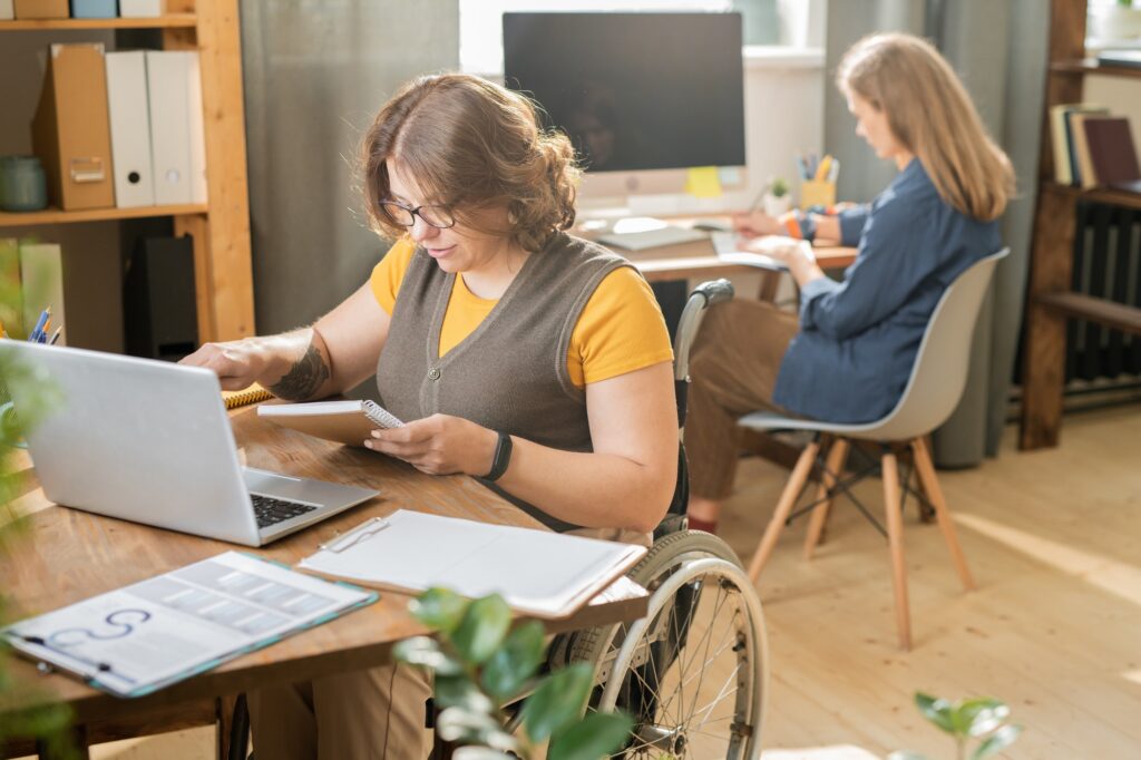 Two woman working in an office on laptops