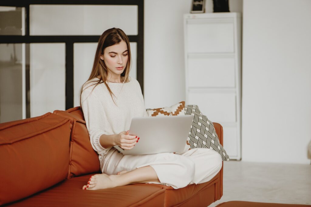 Young woman working from home on laptop.