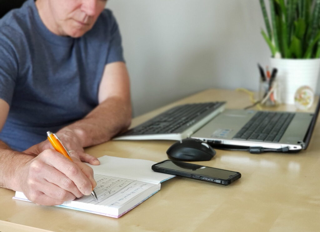 Man is writing in the journal - Image from Inkfire Limited